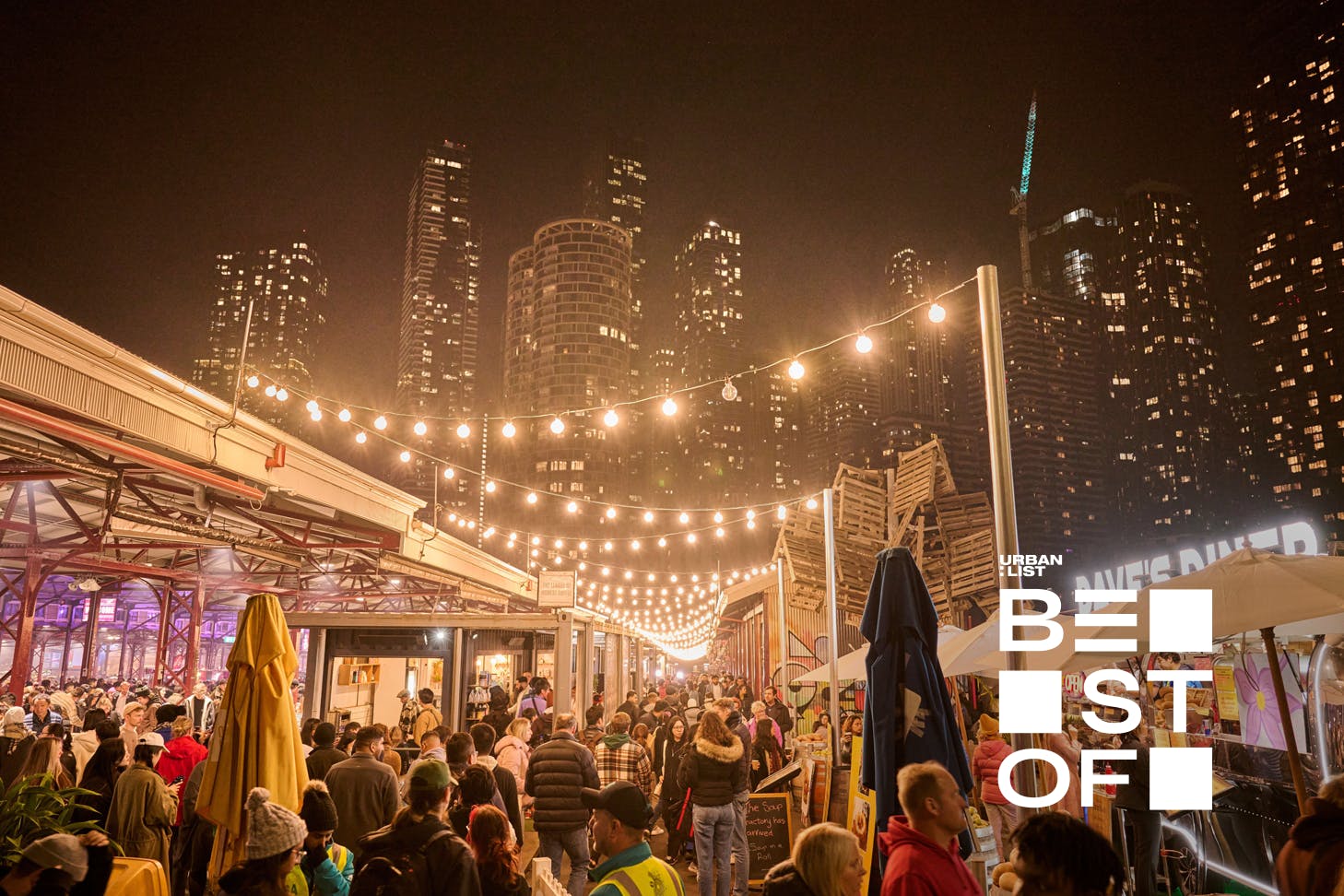 A night market with people walking out among the stars.
